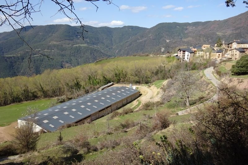 an aerial view of a valley with a building in the foreground