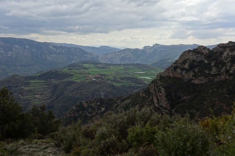 a view of a valley with mountains in the background