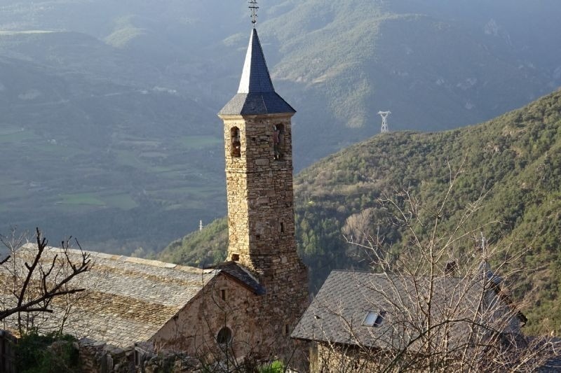 a very tall stone tower with a cross on top of it