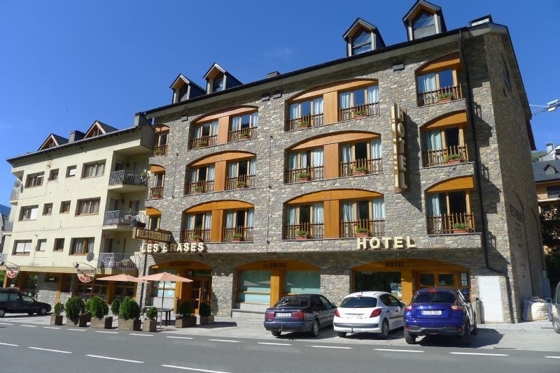 a hotel with cars parked in front of it