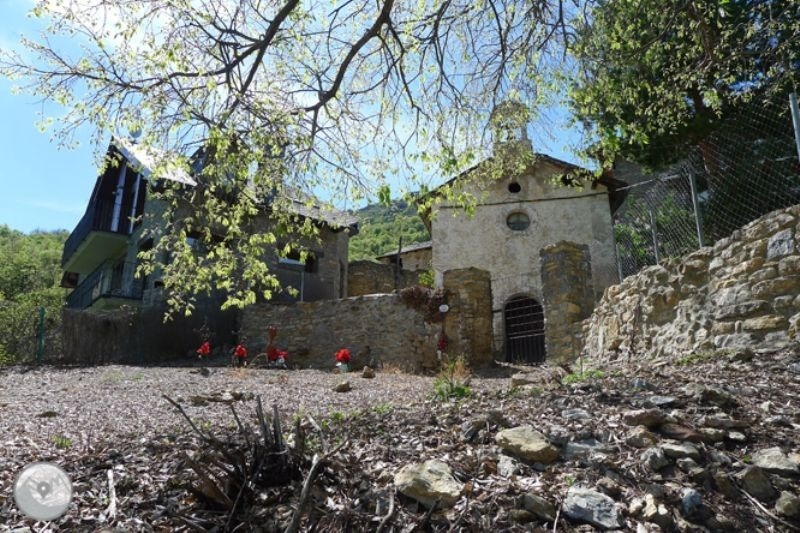 a fenced in area with a stone building in the background