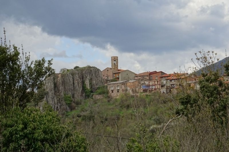 a small village with a tower on top of a hill