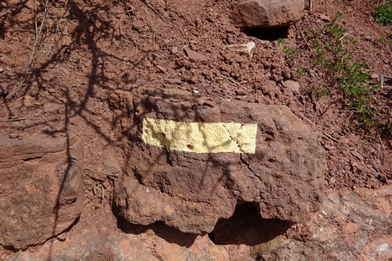 a rock with a yellow arrow pointing to the right