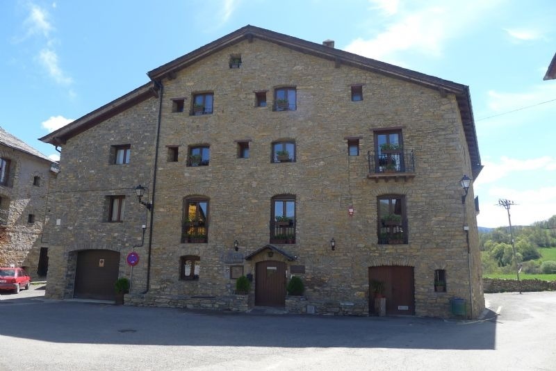 a large stone building with a no parking sign on the side