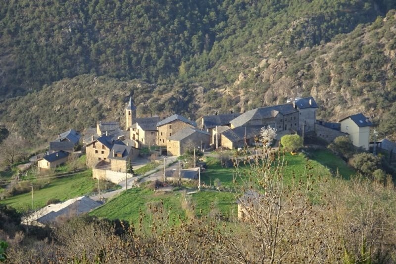 a small village with a church on top of a hill