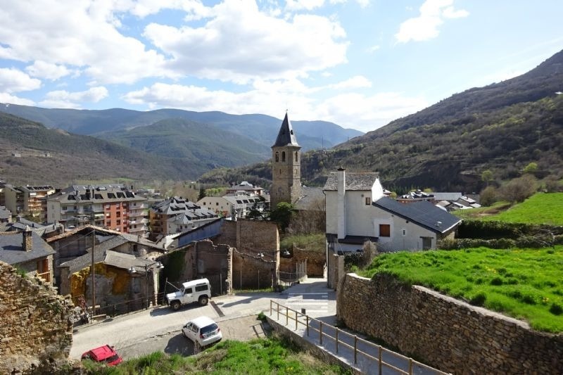 a small town in the mountains with a church in the middle