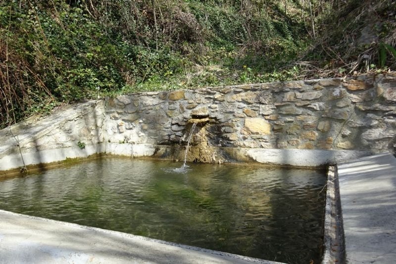 a waterfall is coming out of a stone wall