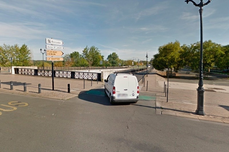 a white van is parked on the side of the road