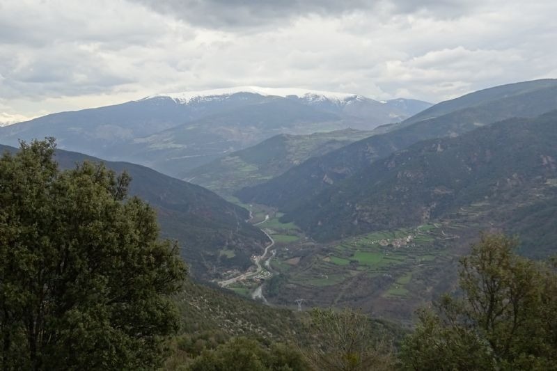 a view of a valley with mountains in the background