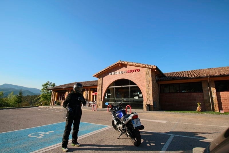 a motorcycle is parked in front of a museum of moto
