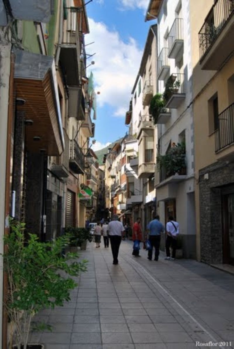 a photo of people walking down a narrow street was taken in 2011