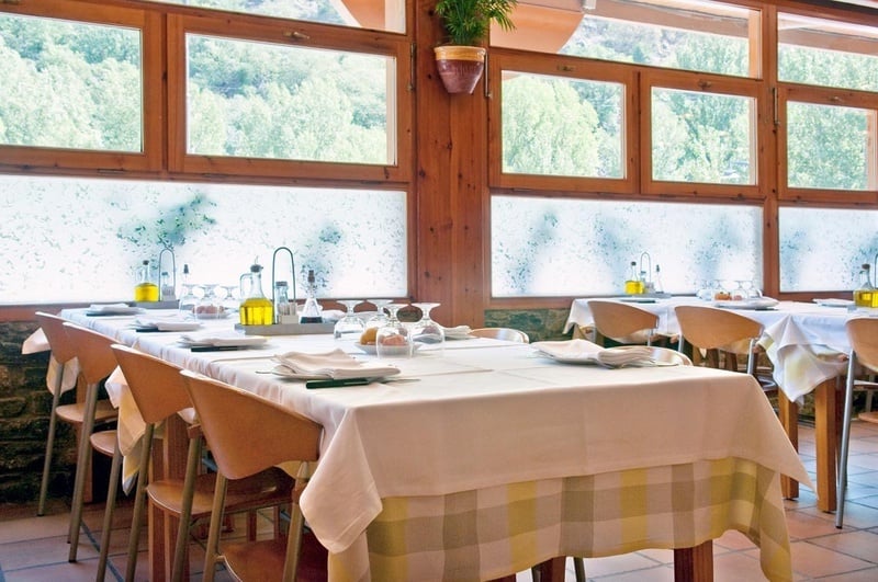 una sala de menjar amb dues taules i dues cadires