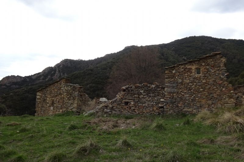 a stone building with a mountain in the background