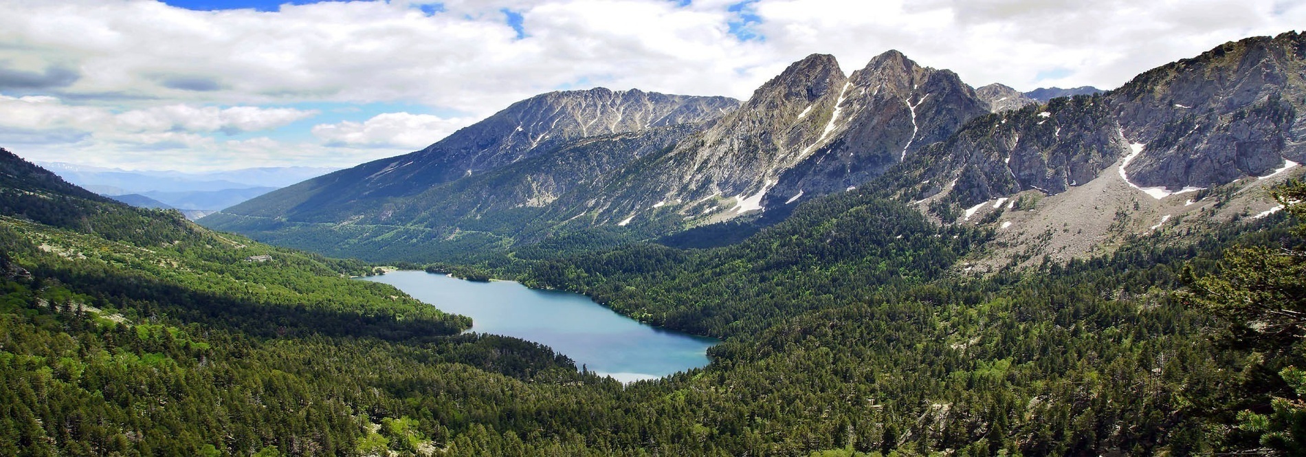 a lake in the middle of a valley surrounded by mountains