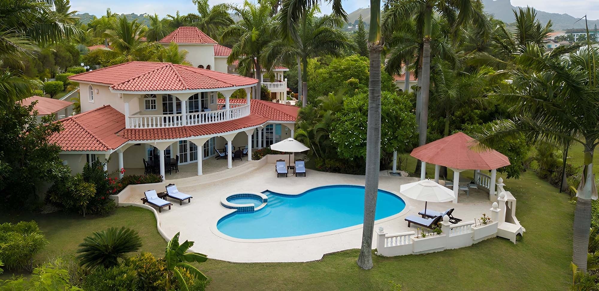 a large swimming pool is surrounded by palm trees