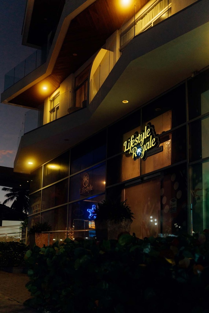 Lifestyle Royale: LHVC Resorts coastal facade illuminated at night.
