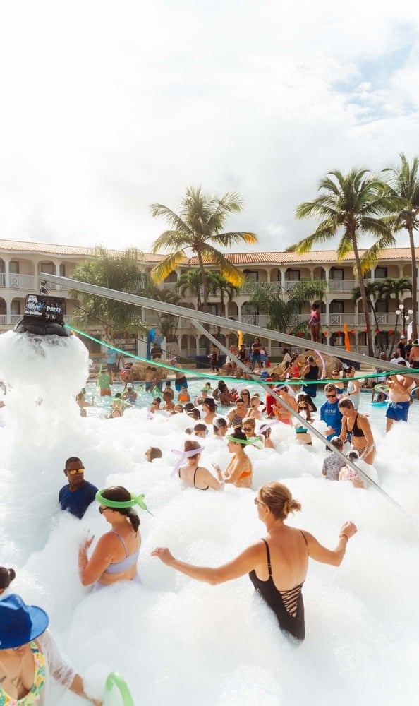 LHVC Resorts: Corpo foam party in the pool, people enjoying the water.