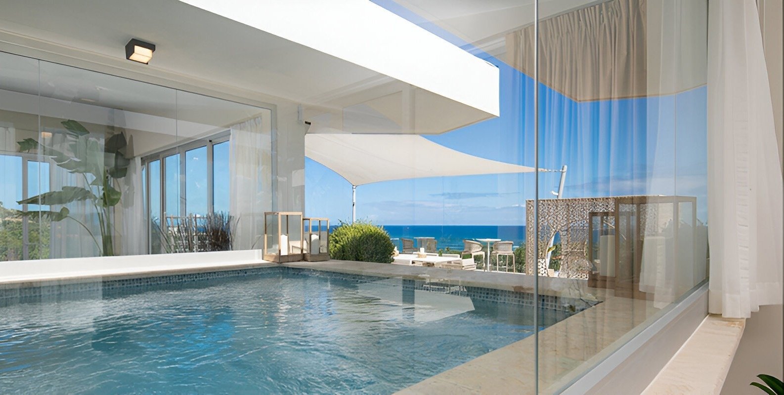a large swimming pool with a view of the ocean