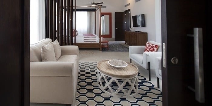 a living room with a couch , chair , coffee table and television .