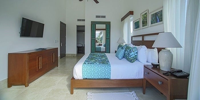 a bedroom with a king size bed , nightstand , television and dresser .