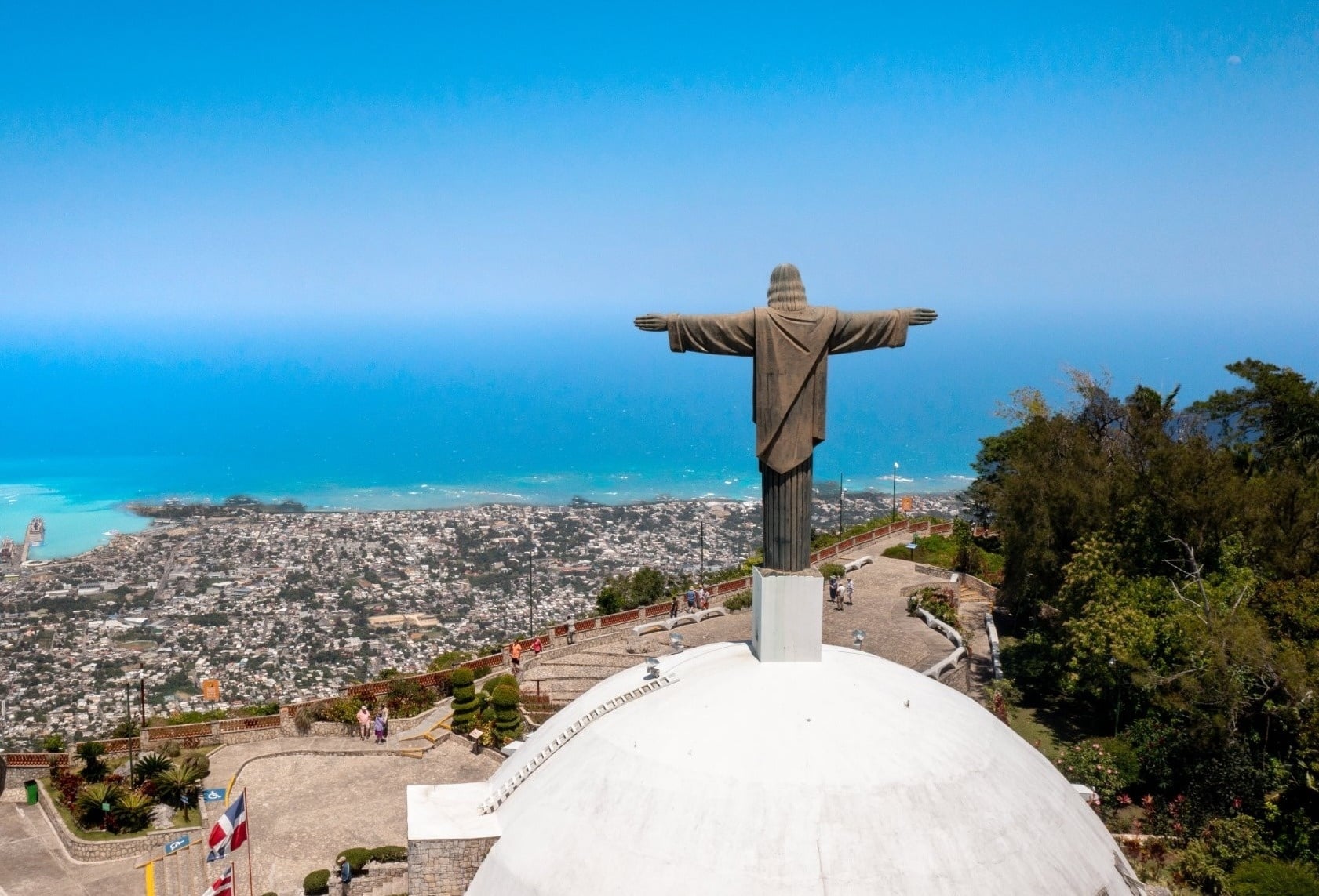 two blue gondolas are hanging from power lines against a blue sky