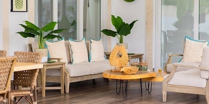a living room with a couch , chairs , tables and a wooden table .
