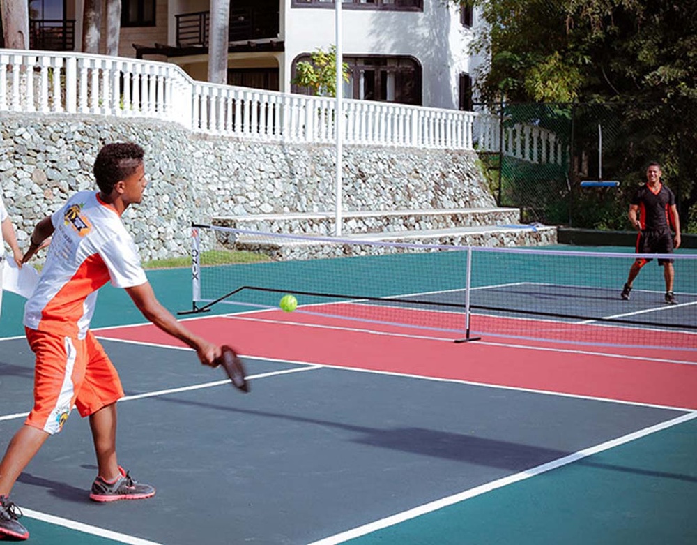 Outdoor pickleball players at LHVC Resorts: Corpo, enjoying the sun and game.
