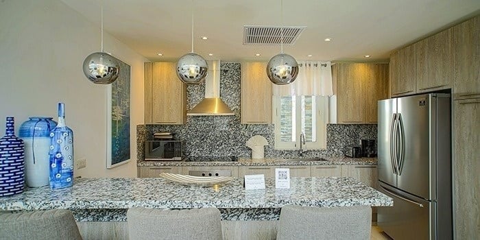 a kitchen with granite counter tops and stainless steel appliances .