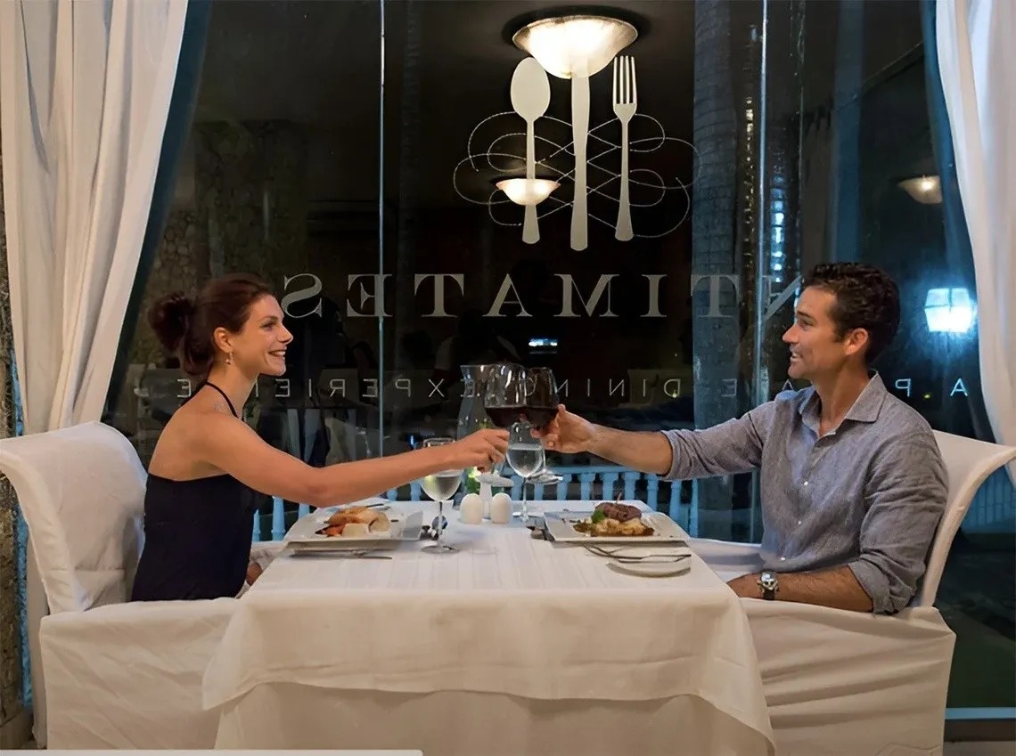 a dining room with tables and chairs and a green wall