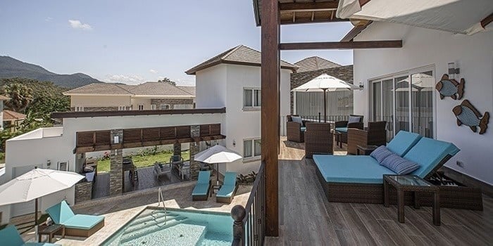 there is a large swimming pool in the backyard of a house .