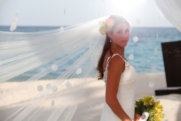 a bride with her veil blowing in the wind