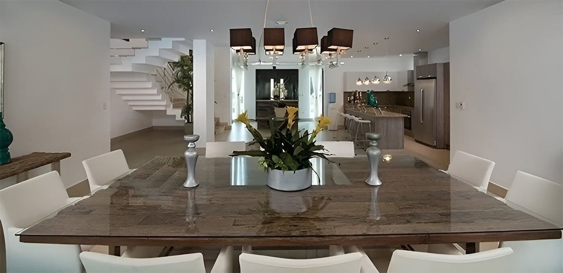 a dining room table with a vase of flowers on it