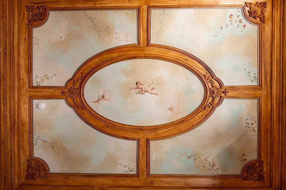 a ceiling with a painting of angels on it