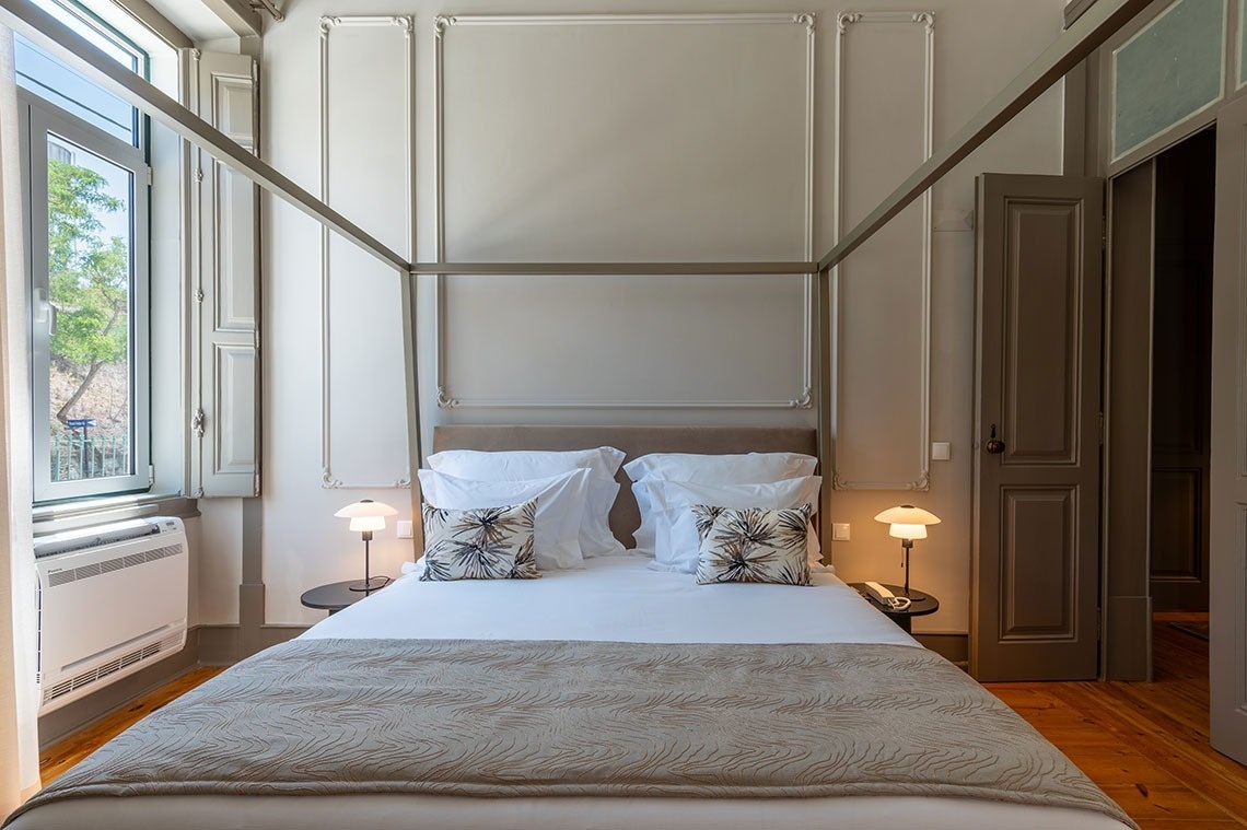 a bedroom with a canopy bed and a window