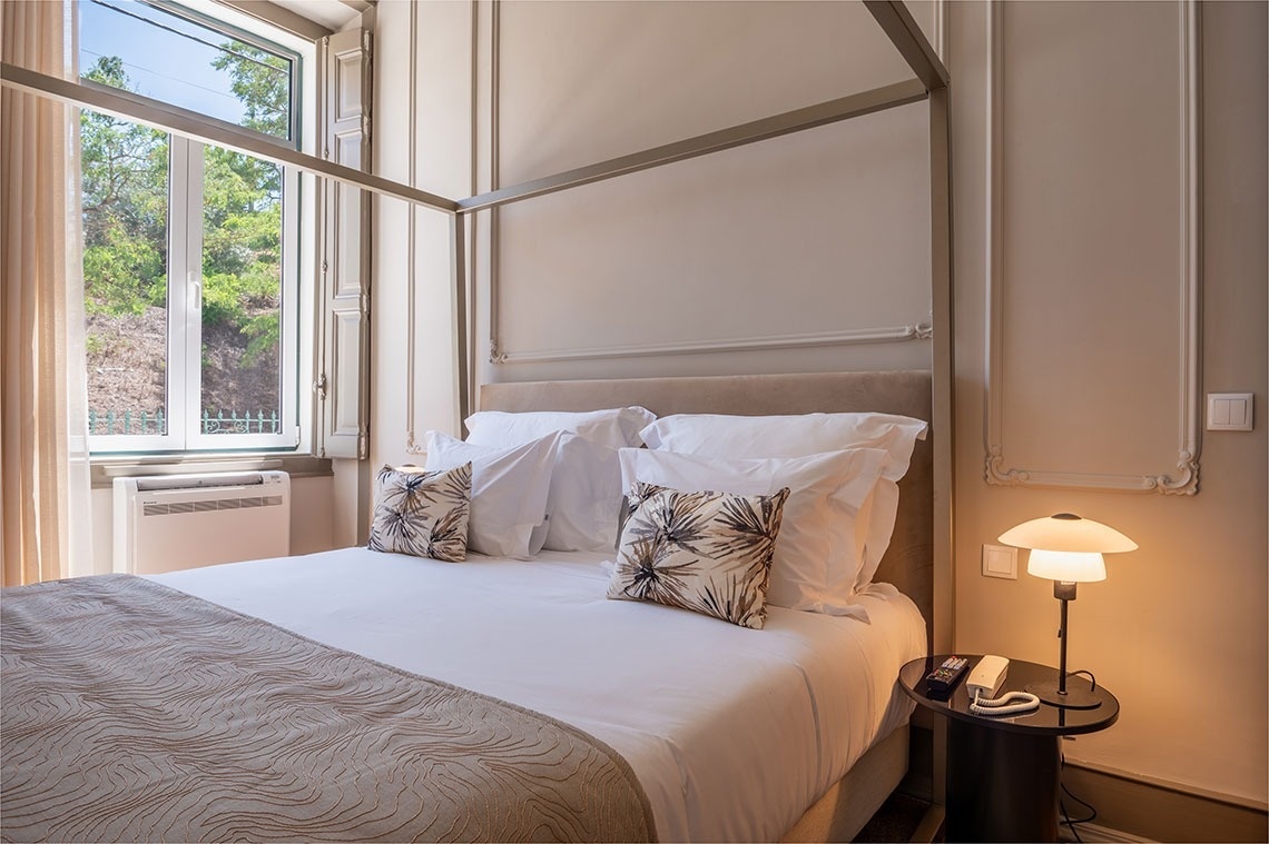 a bedroom with a canopy bed and a window