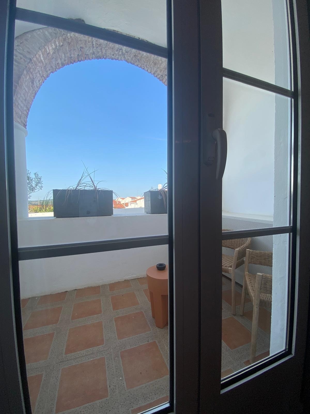 a view of a balcony through a glass door