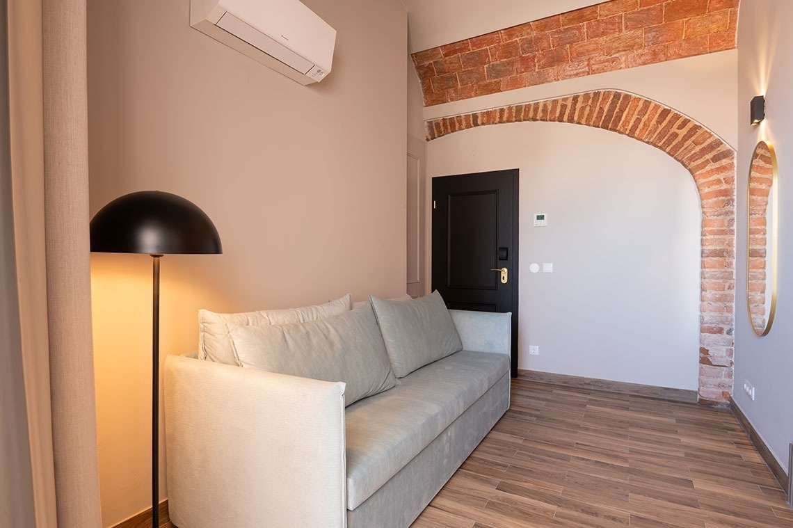 a living room with a couch and a black door