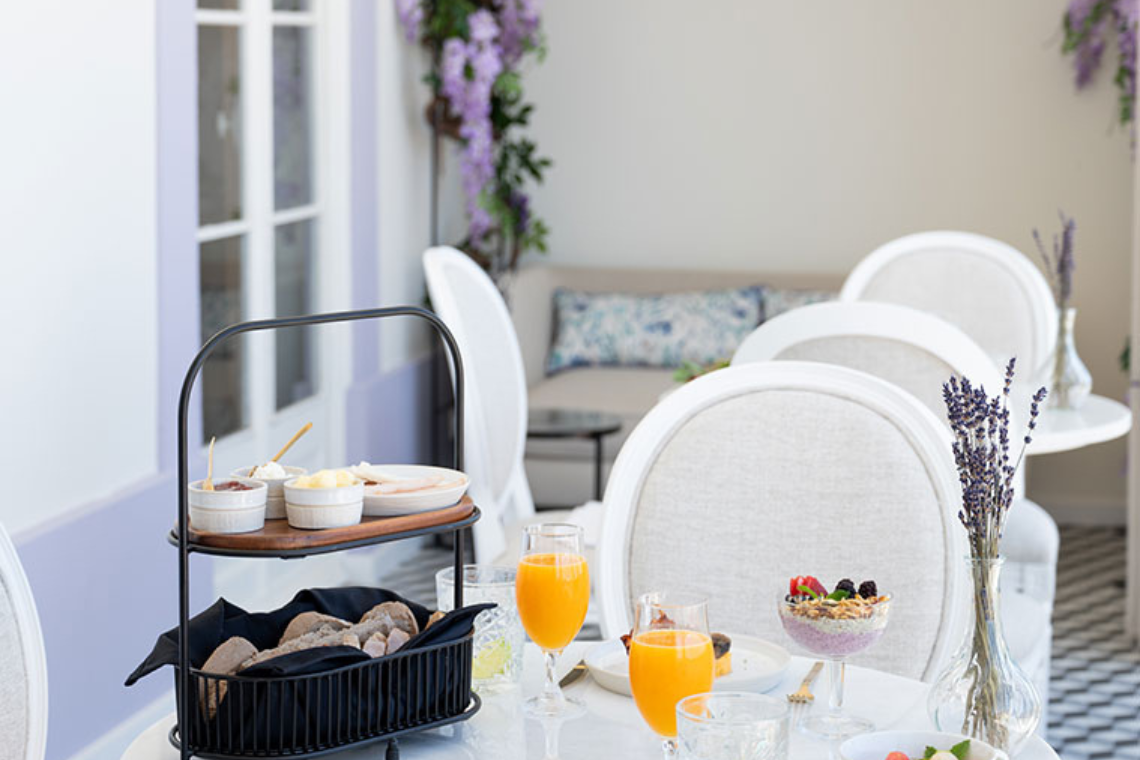 uma mesa com pratos e taças de suco de laranja