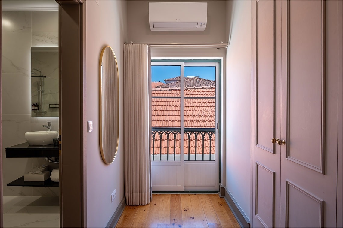 a bathroom with a sliding glass door leading to a balcony