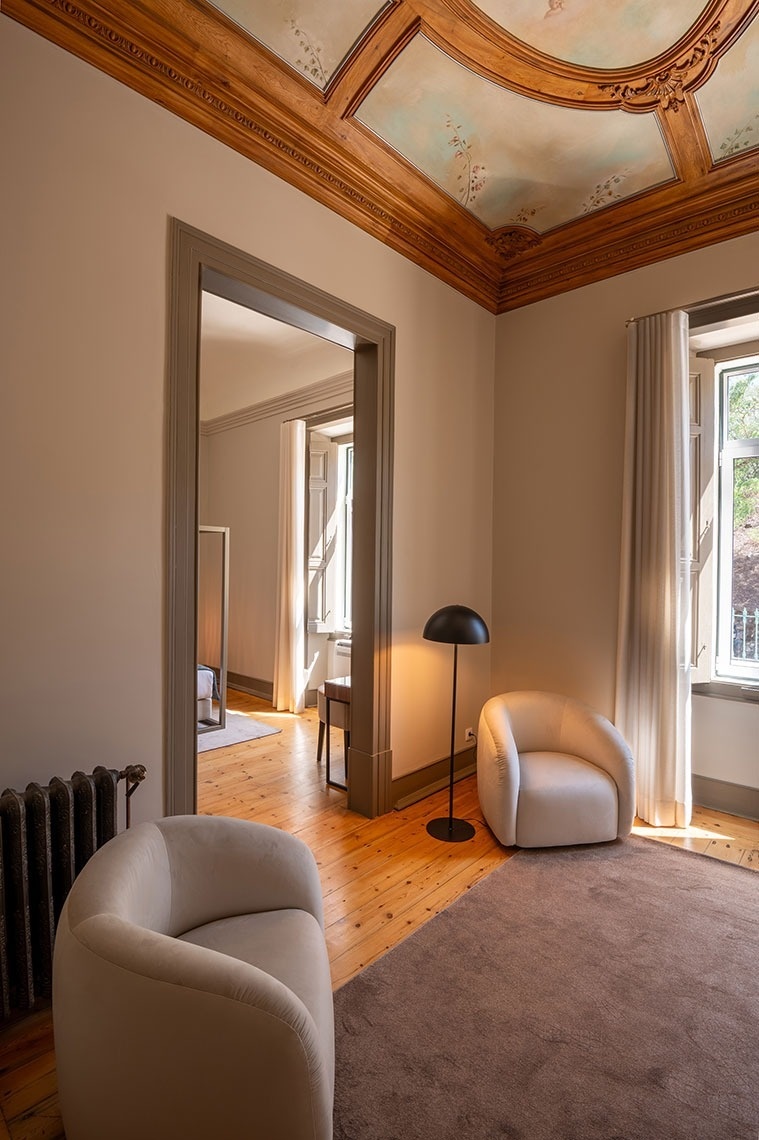 a living room with a chair and a lamp