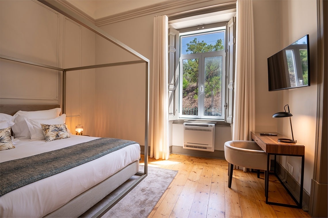 a bedroom with a canopy bed and a desk