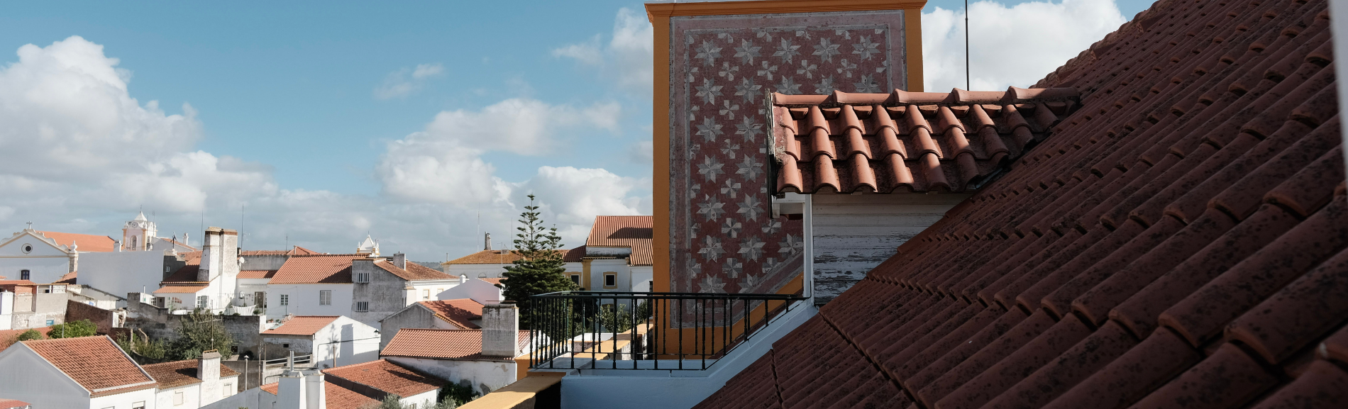 the roof of a building with a balcony overlooking a city