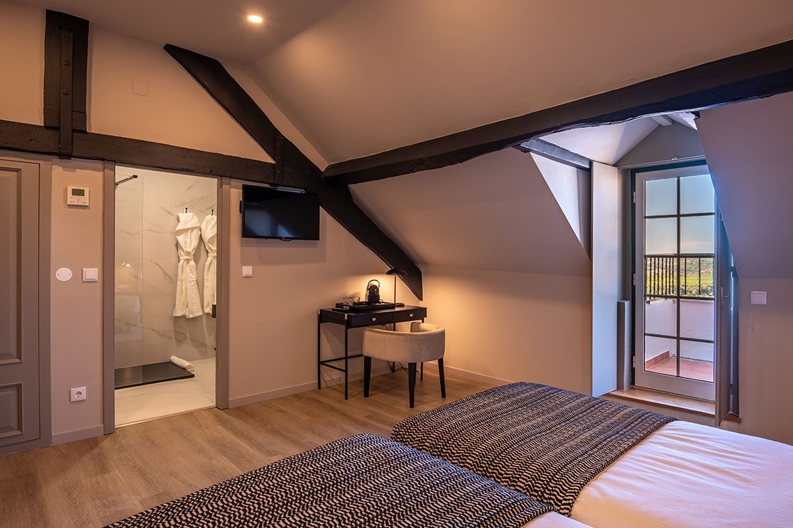 a bedroom with two beds and a television on the wall