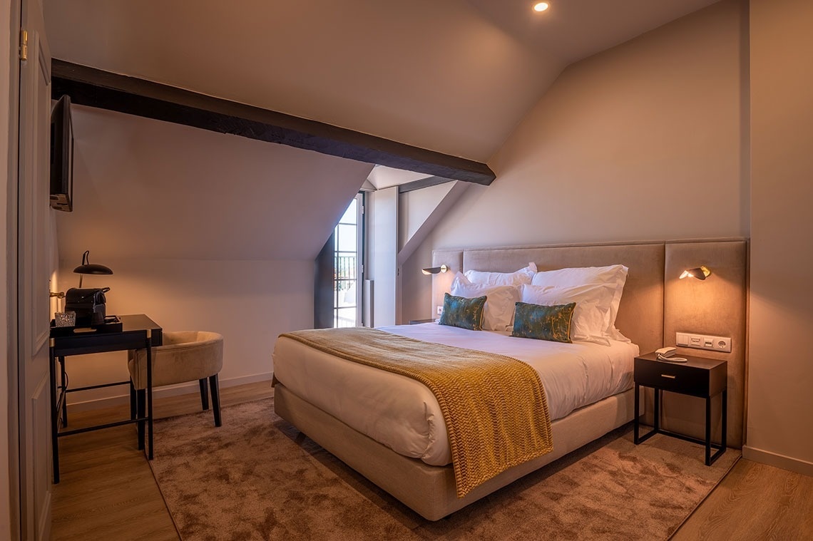 a hotel room with a bed and a desk