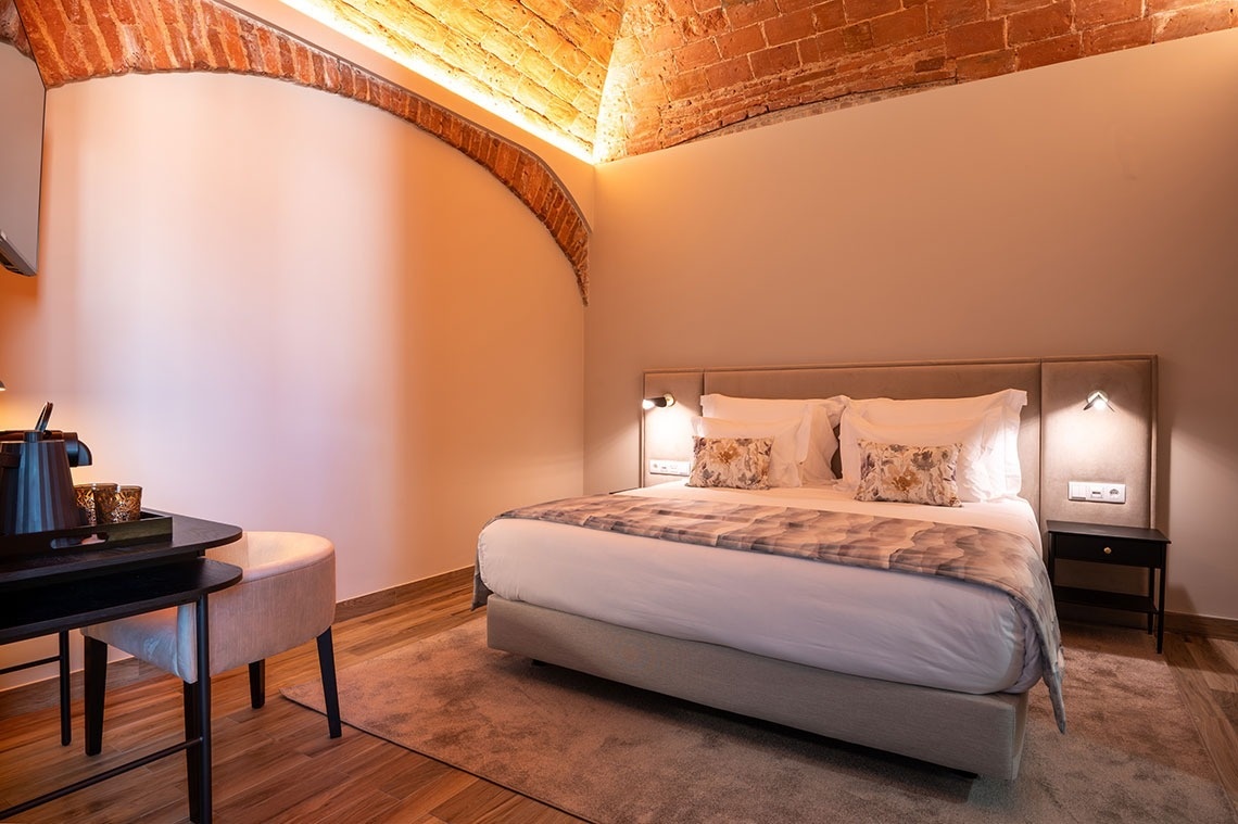 a hotel room with a bed and a desk