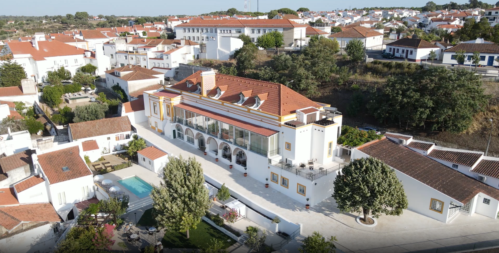 una piscina con sillas y sombrillas alrededor de ella