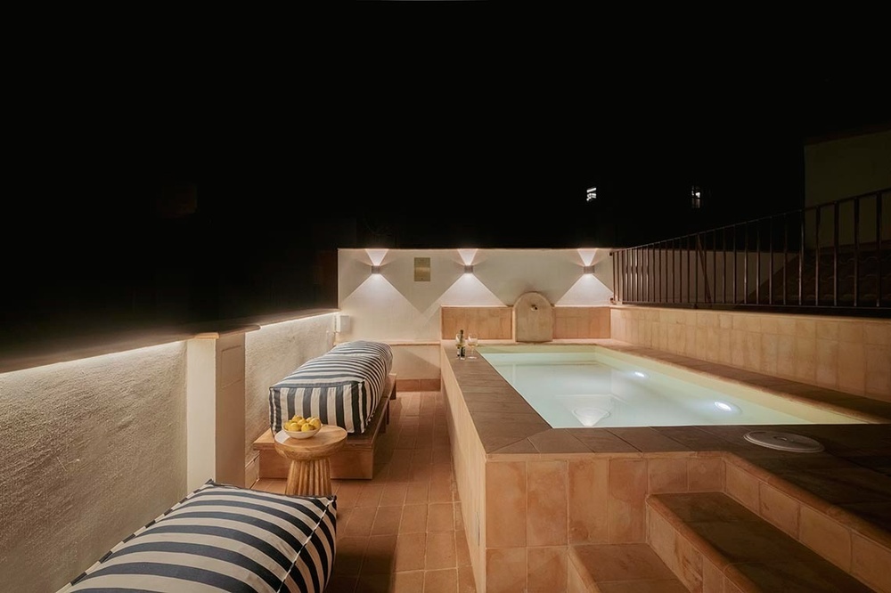 una terraza con mesas y sillas y una piscina