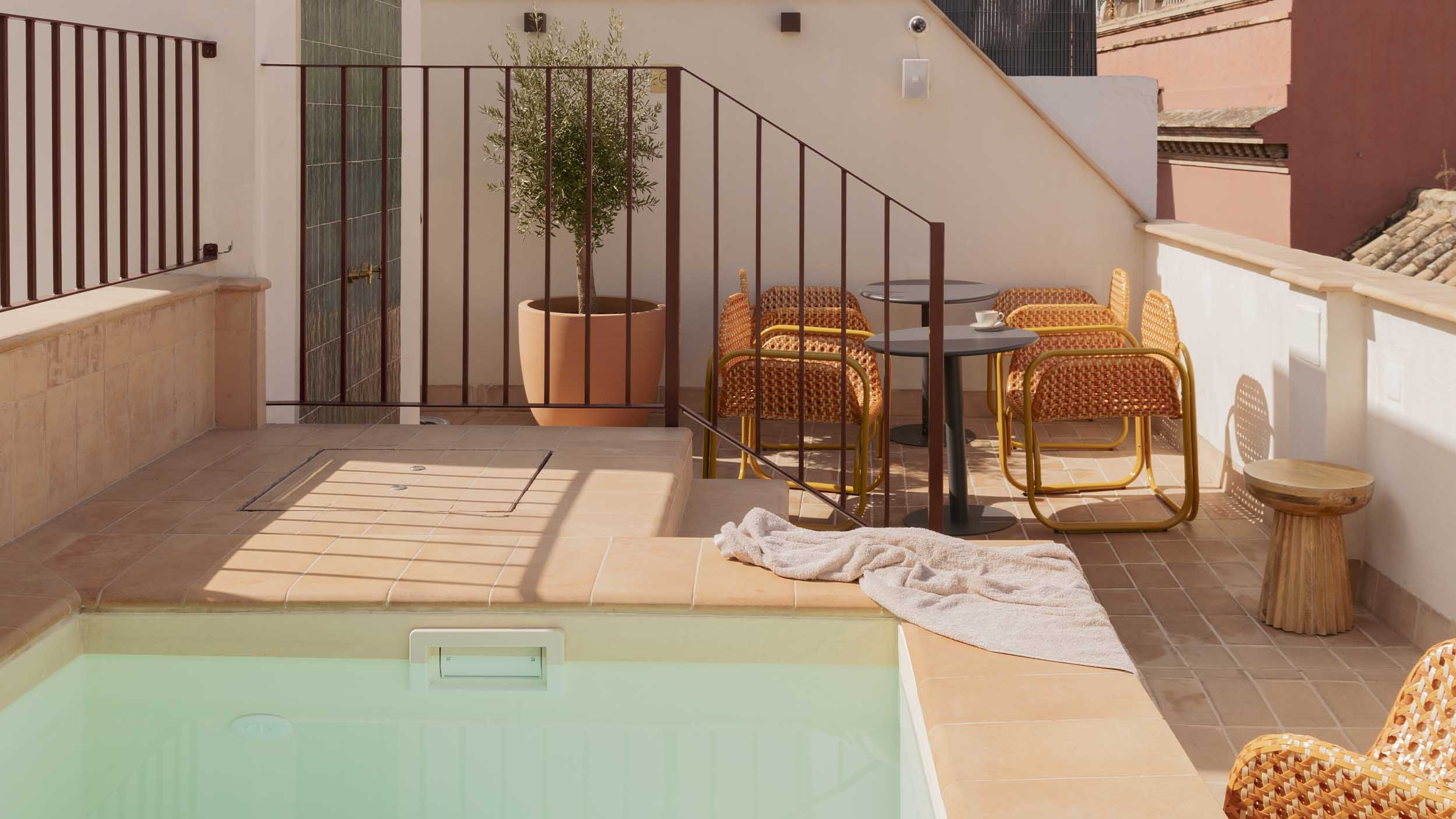 Lirium terrace with plunge pool, striped cushion, and blue sky views.