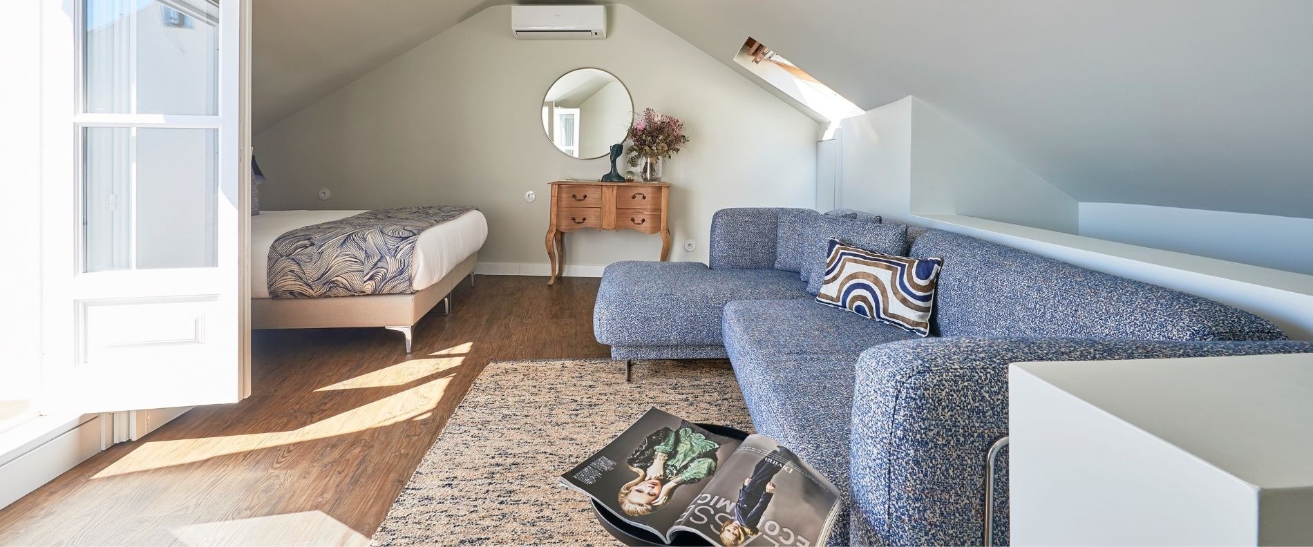 a living room with a couch and a painting on the wall