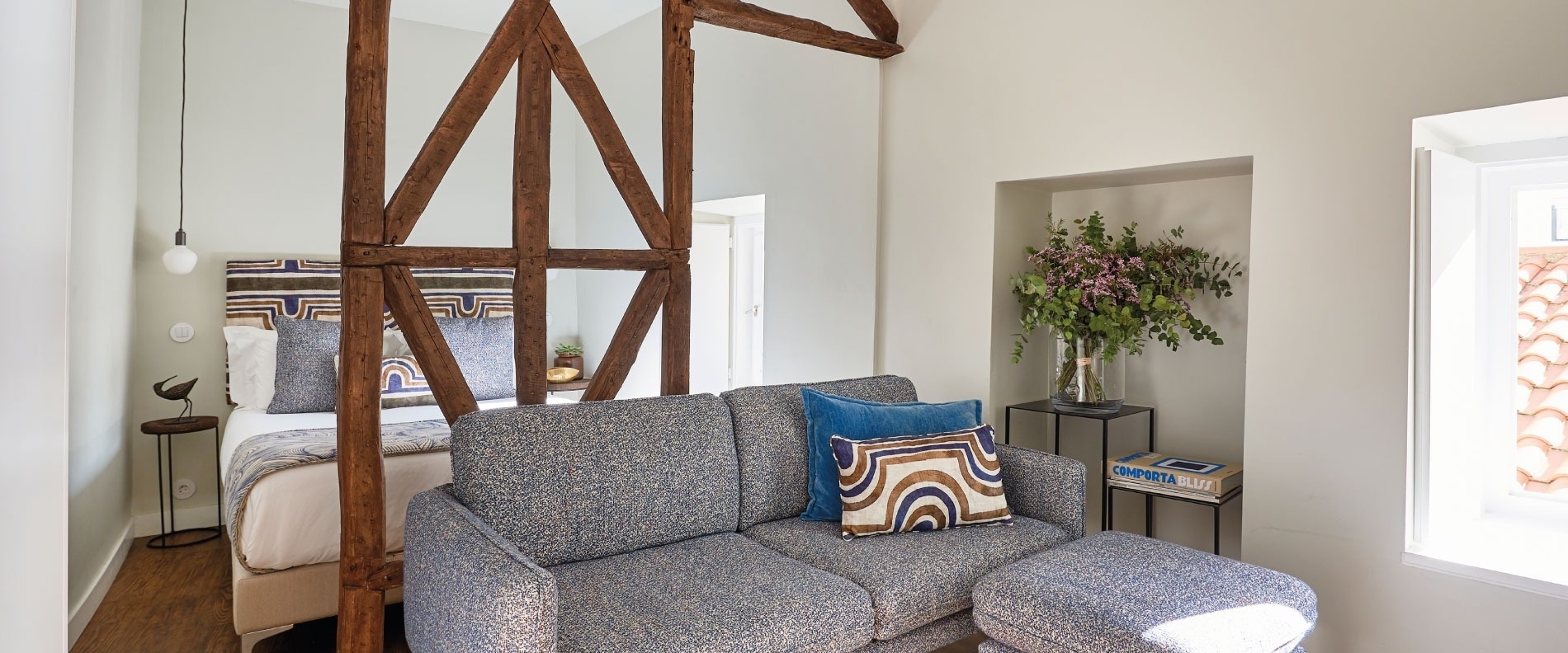 a living room with a couch and a painting on the wall